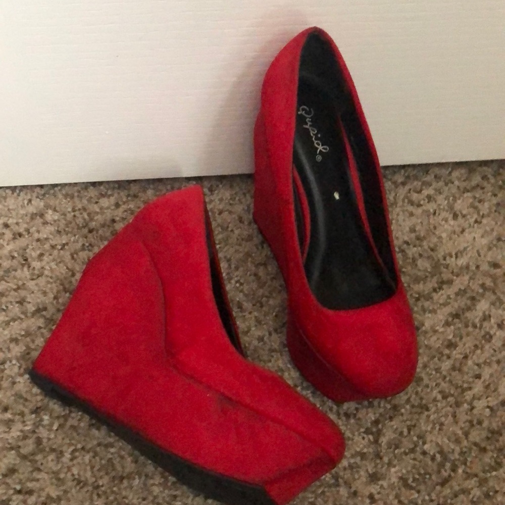 Red suede platform wedges. Has dark spots on heel